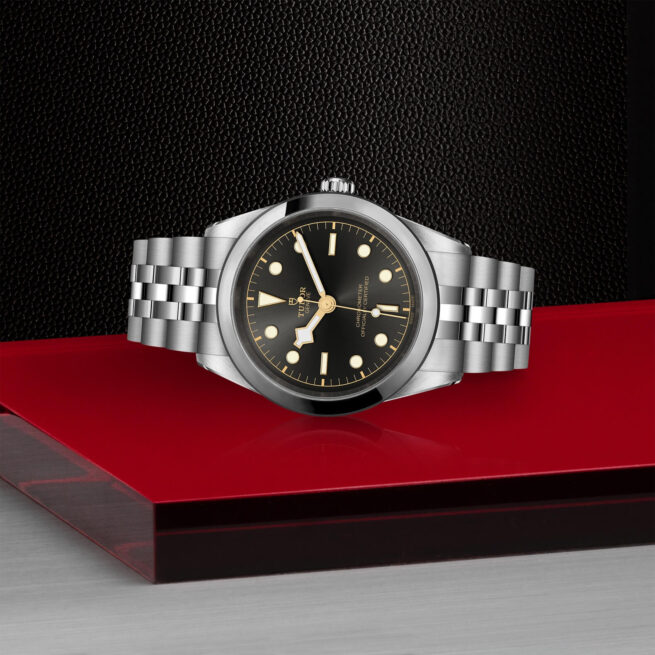 A M79680-0001 watch on a red table.