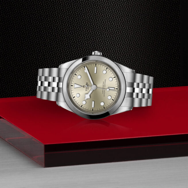 A M79680-0003 oyster watch on a red table.