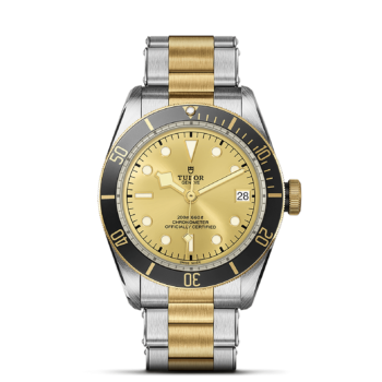 A M79733N-0004 yellow dial watch on a black background.