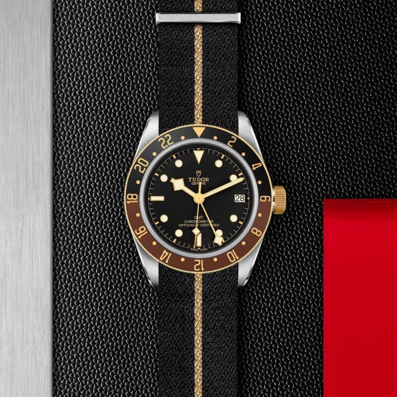 The M79833MN-0004 watch is on a black leather strap.