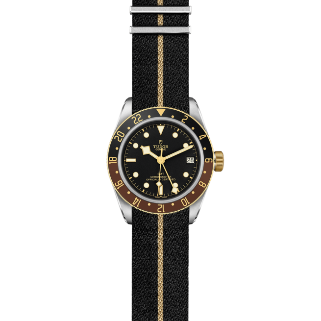 The tudor M79833MN-0004 watch on a black and gold strap.