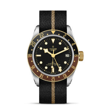 The M79833MN-0004 watch with gold and black bezel.