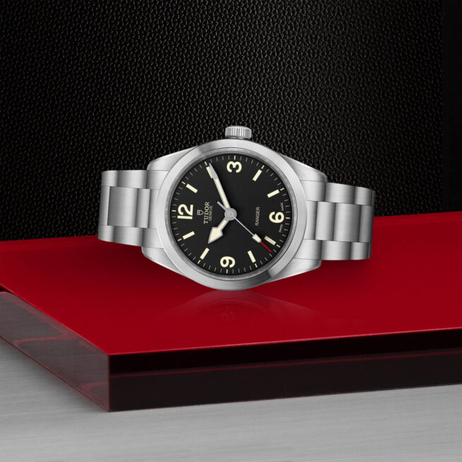 A M79950-0001 watch on a red surface.