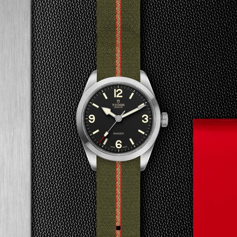 A M79950-0003 on a black leather strap with red and green stripes.
