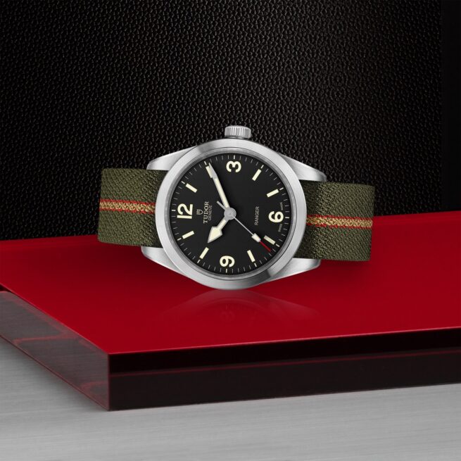 A M79950-0003 with a red strap sitting on a red table.