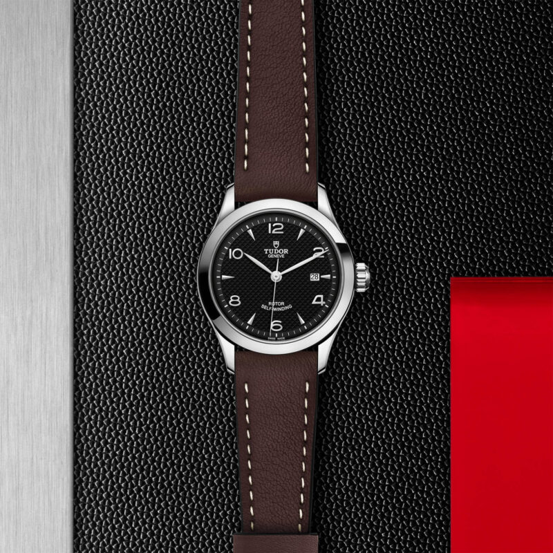 A black and brown M91350-0008 on a black leather strap.