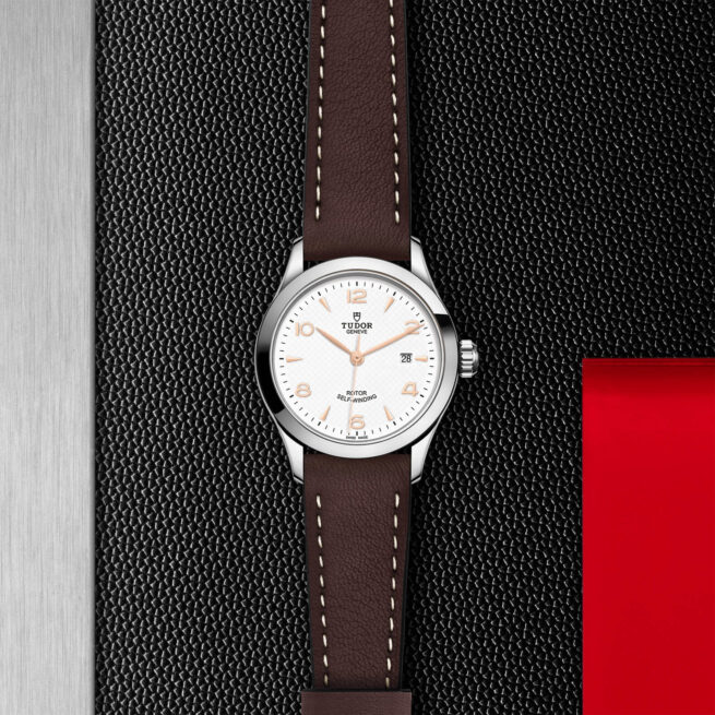 A M91350-0012 with a brown leather strap on a black background.