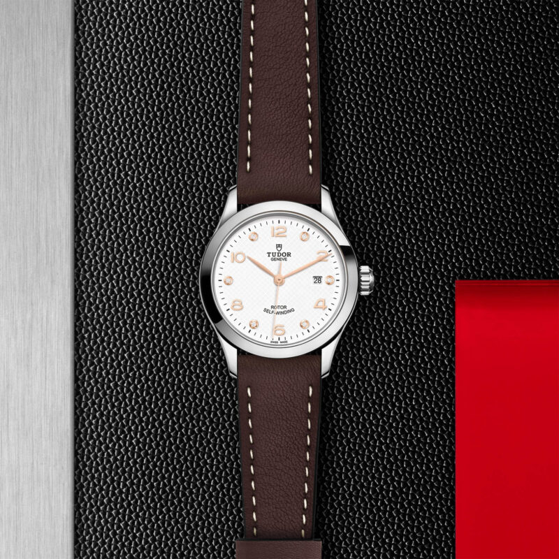A M91350-0014 with a brown leather strap on a black background.