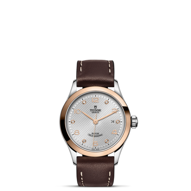 A M91351-0006 with brown leather straps and a white dial.