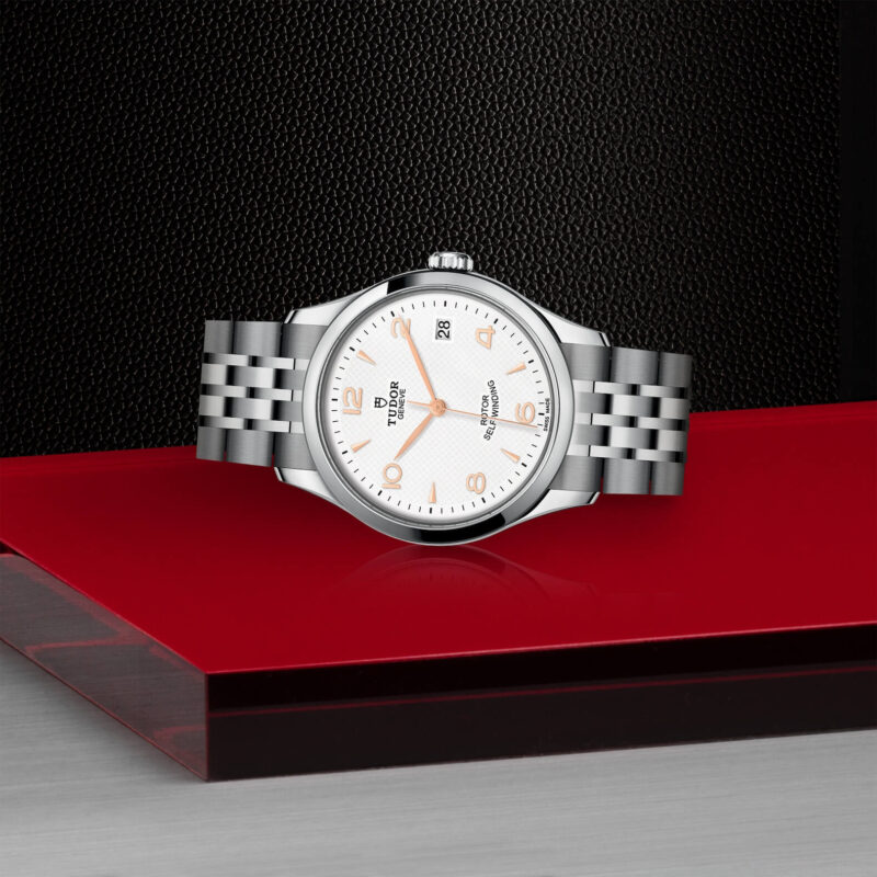 A M91450-0011 watch on a red table.