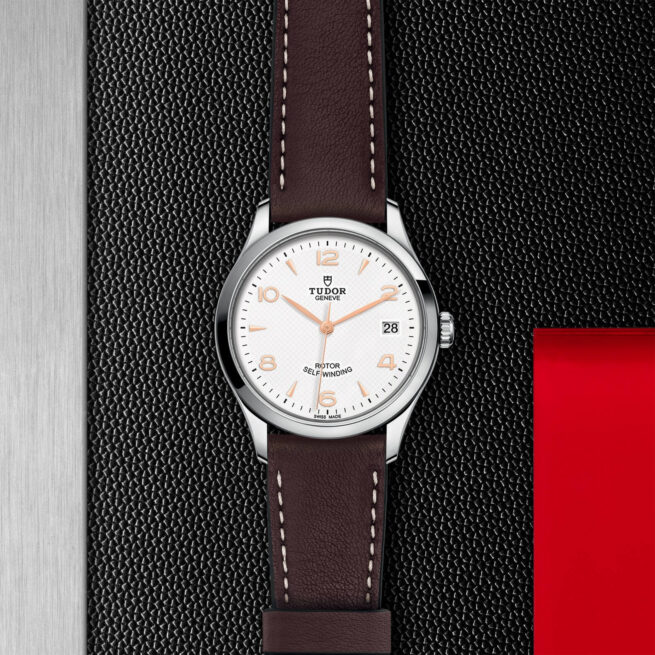 A watch with a brown leather strap on a red background. Product Name: M91450-0012