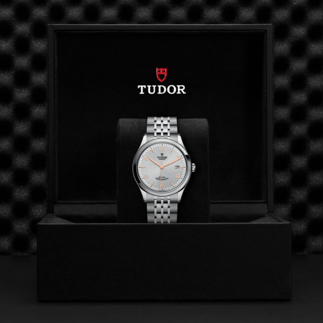 A silver M91550-0001 watch in a gift box.