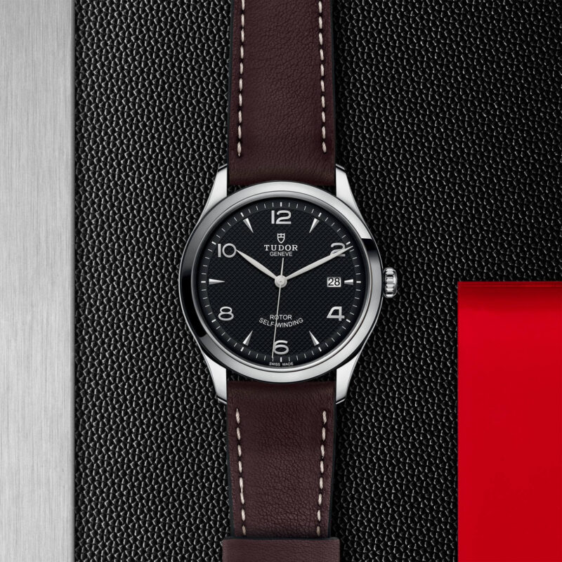 A M91550-0008 watch with a red strap.