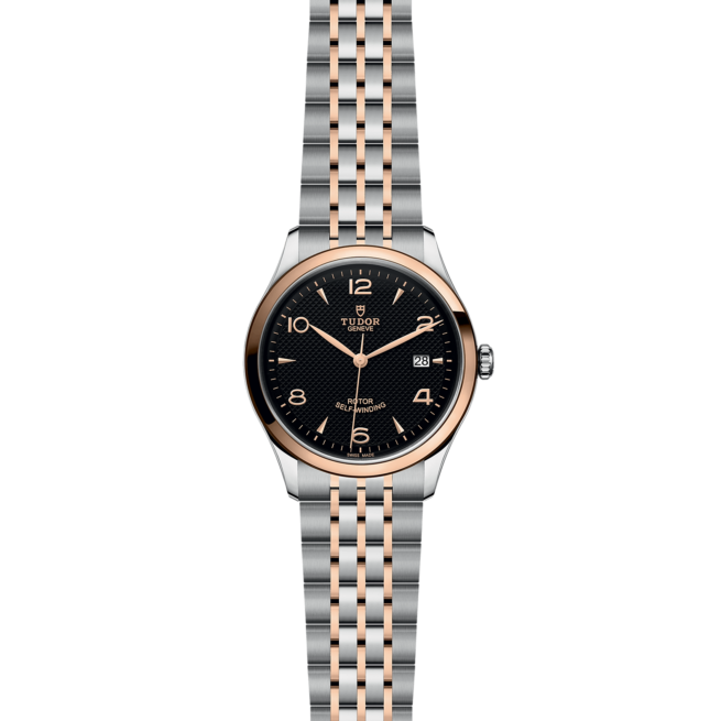 A black and rose gold watch on a black background.