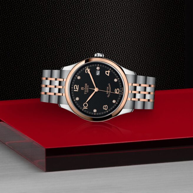A M91551-0004 watch on a red table.