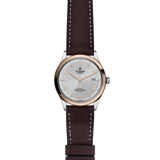 A women's watch with brown leather strap.