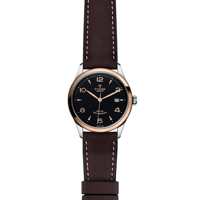 A watch with brown leather straps on a black background.