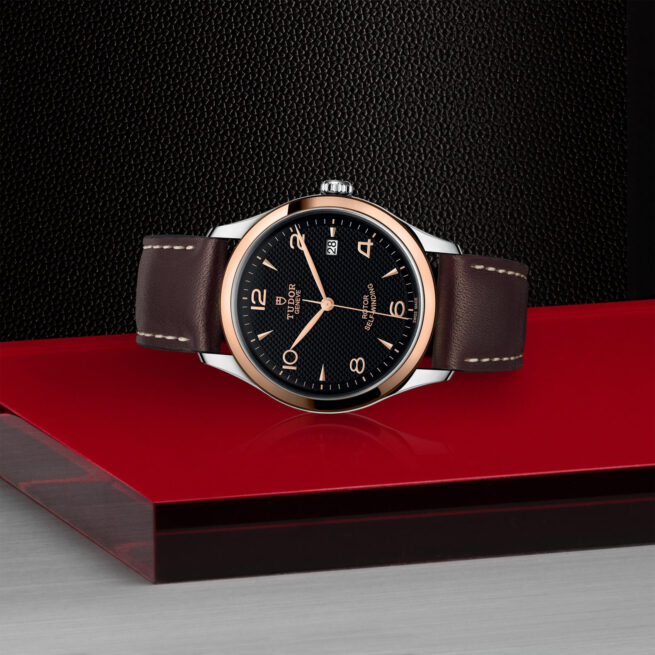 A M91551-0007 watch on a red table.