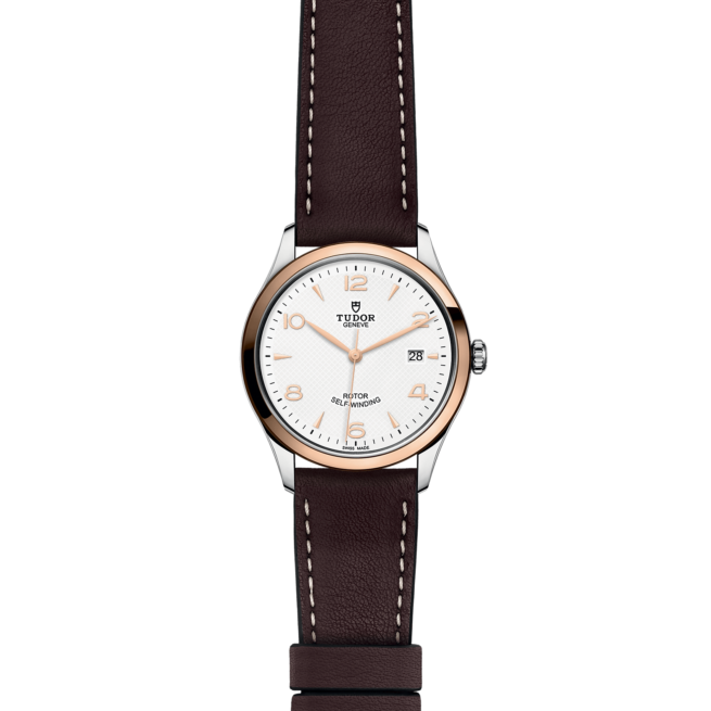 A watch with a brown leather strap and white dial.