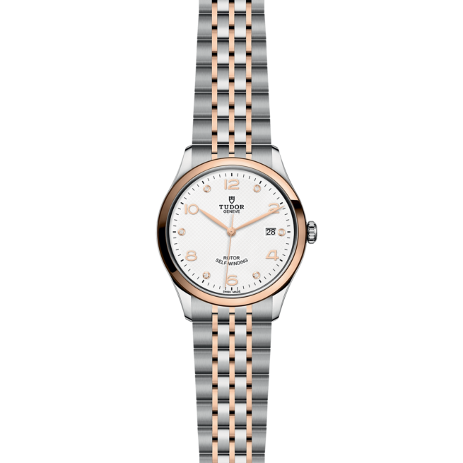 A ladies watch with a silver and rose gold bracelet.