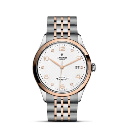 The tissot classic watch with a white dial and rose gold bracelet.