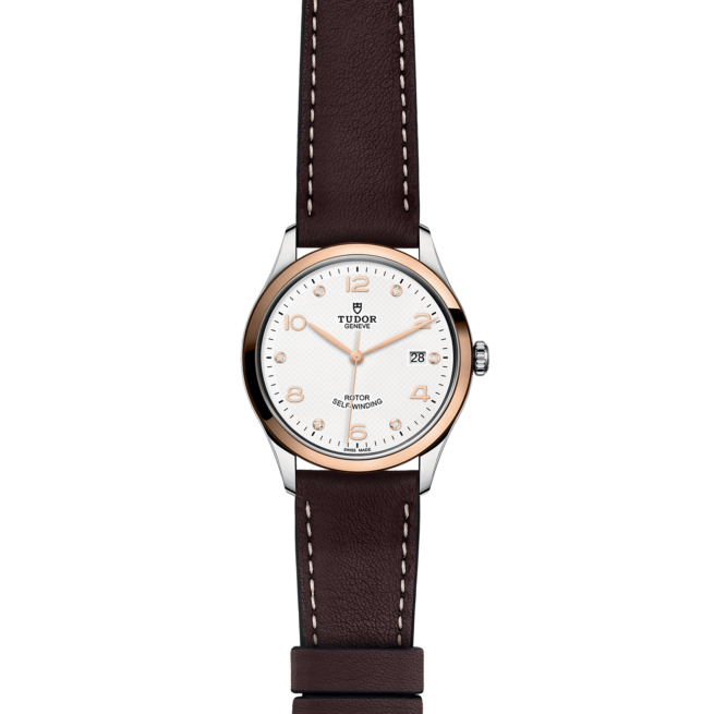 A white and brown watch with a brown leather strap.