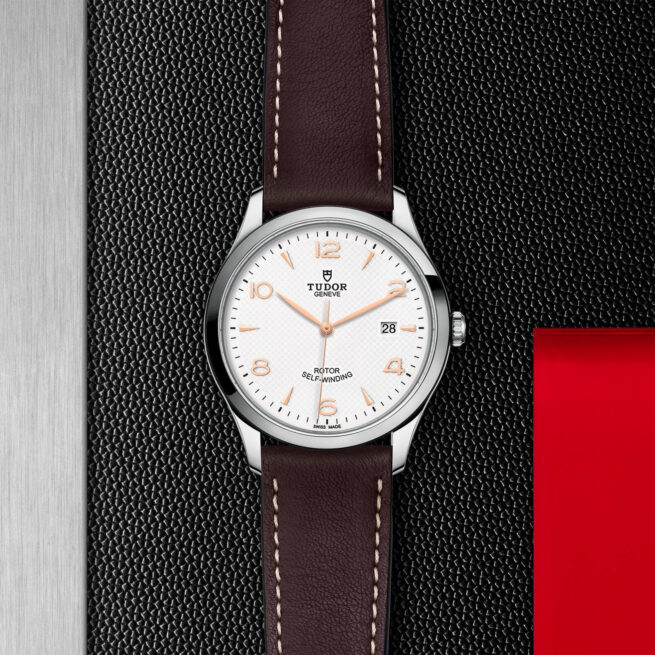 A watch with a brown leather strap on a black background, the M91650-0012.