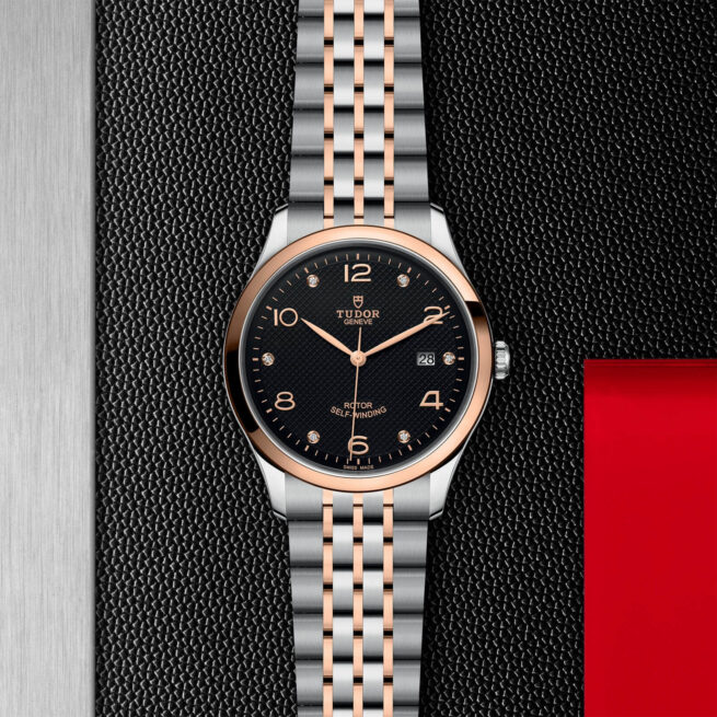 A M91651-0004 watch on a black leather background.