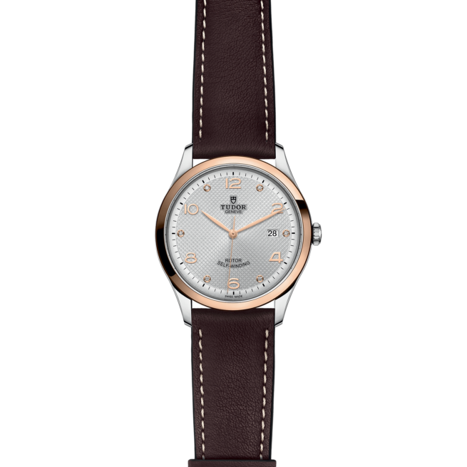 A M91651-0006 with a brown leather strap on a black background.