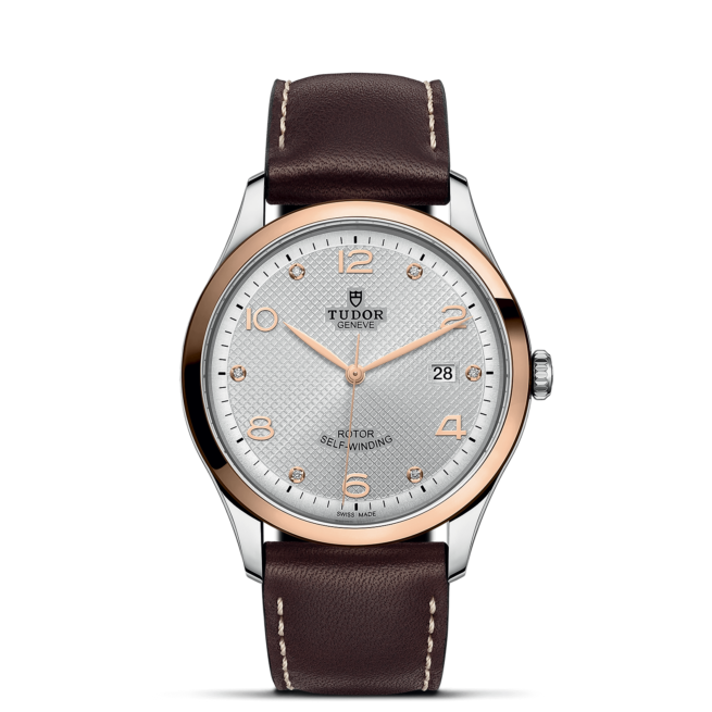 A M91651-0006 with brown leather straps and a white dial.