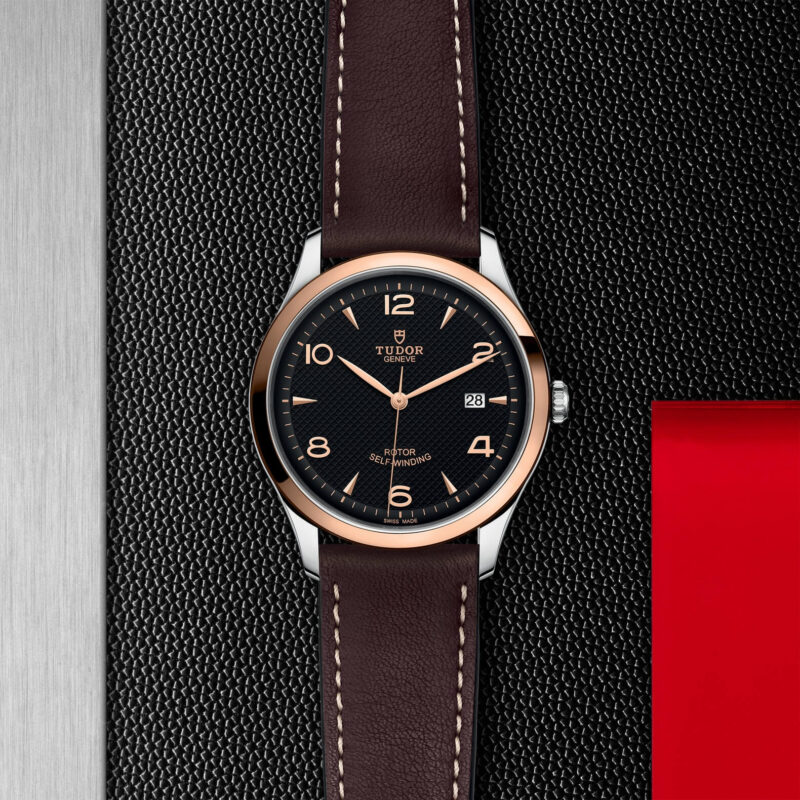 A watch with a M91651-0007 leather strap on a red background.