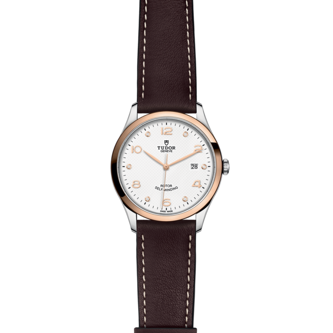 A white and brown M91651-0012 watch on a brown leather strap.