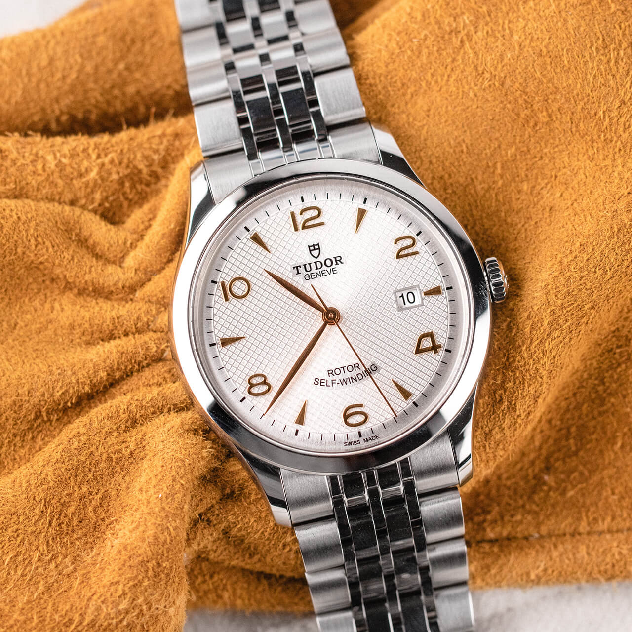 A M91651-0012 watch sitting on a yellow blanket.