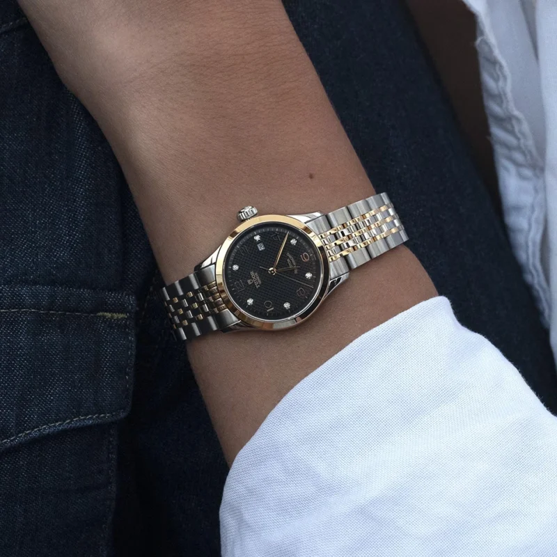 A woman's wrist with a M91351-0004 watch on it.