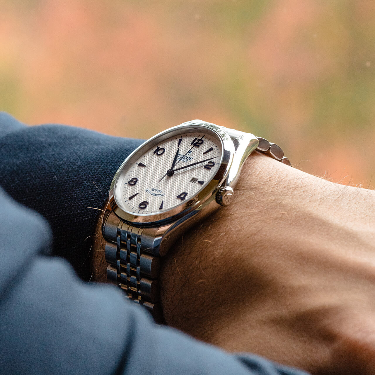 A man's wrist with a M91651-0012 watch on it.