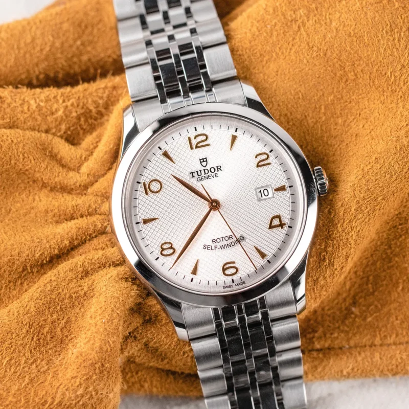 A M91350-0011 watch sitting on a yellow blanket.