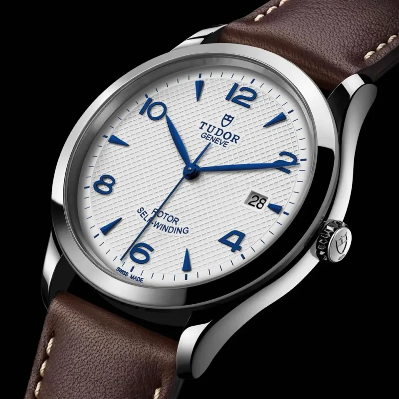 A watch with a M91350-0010 dial and brown leather strap.