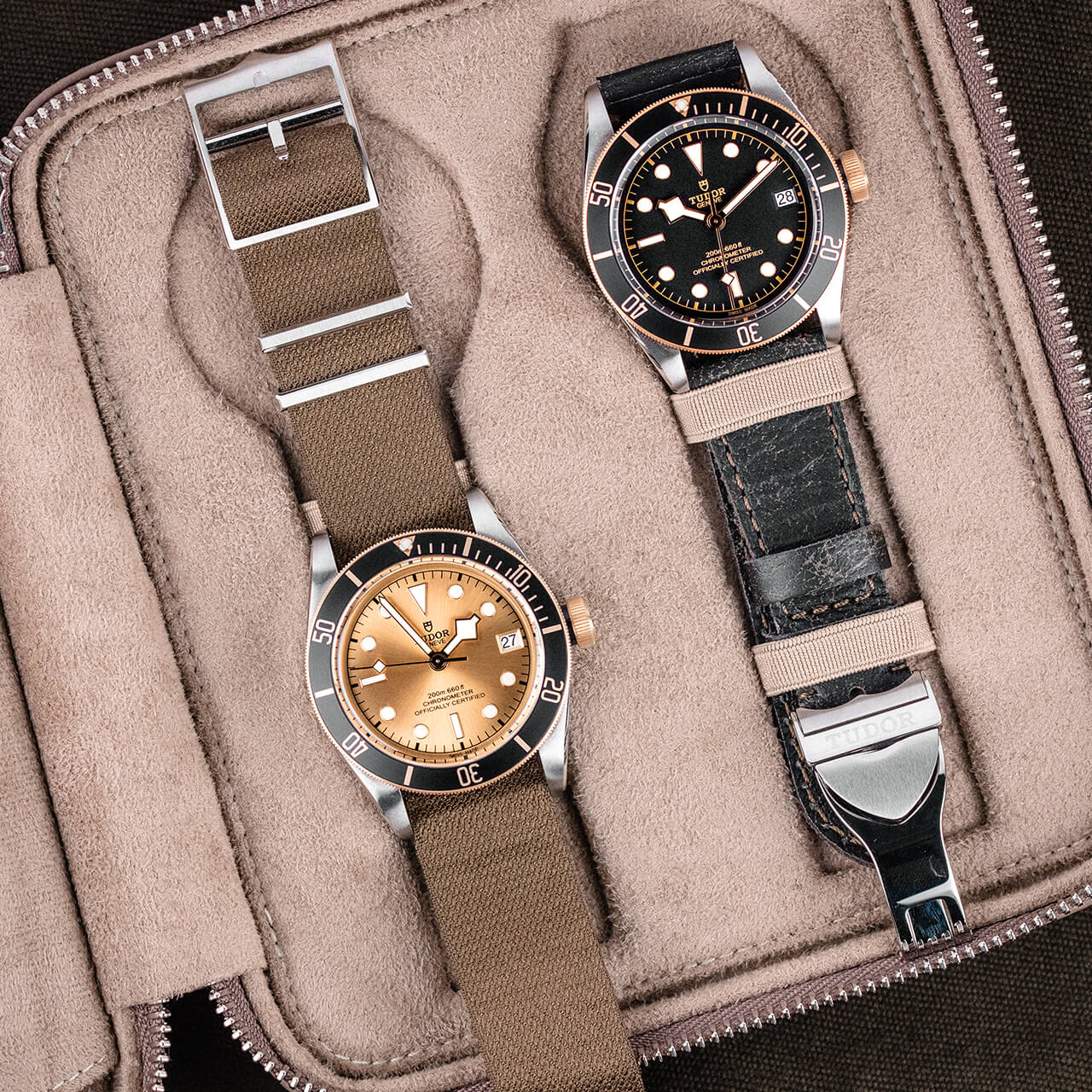 Two M79733N-0008 watches sitting in a leather case.