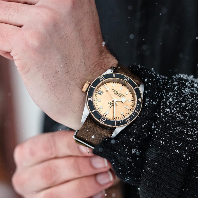 A person wearing a M79733N-0008 watch in the snow.