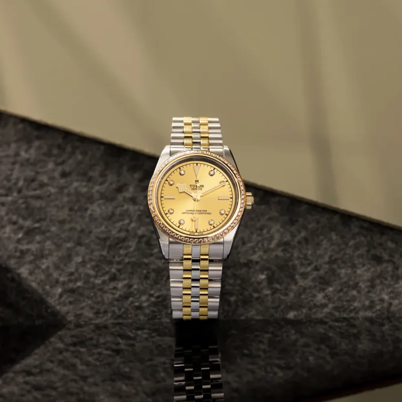 A M79653-0007 watch with a yellow dial on a black background.