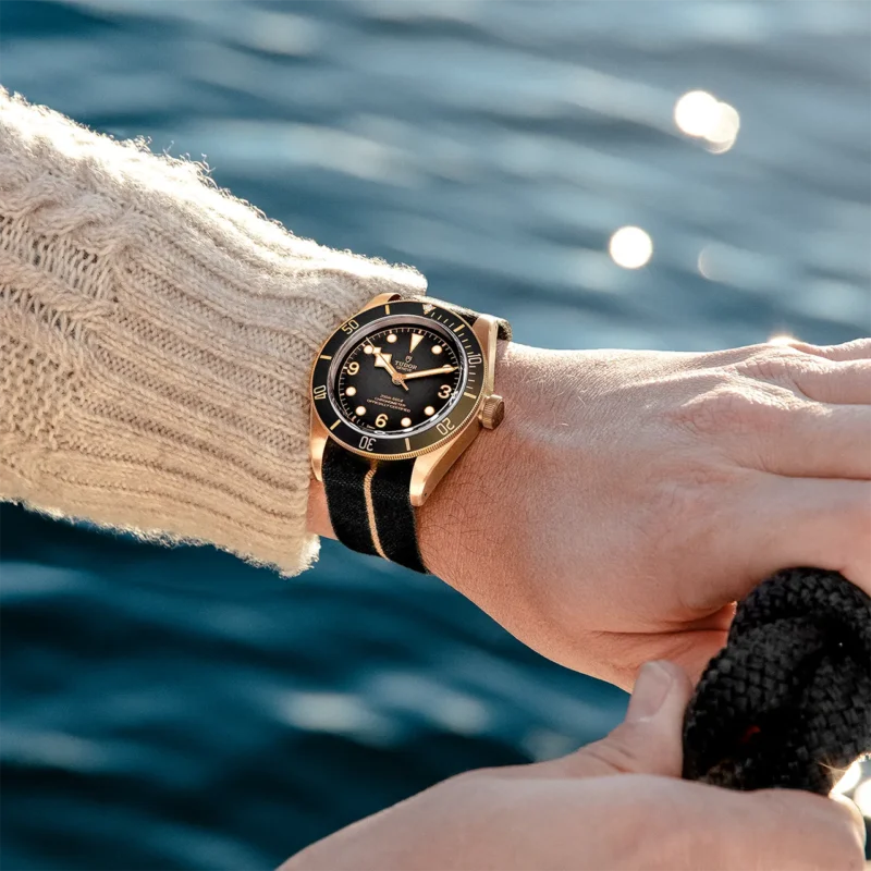 A person holding a M79250BA-0002 on a boat.