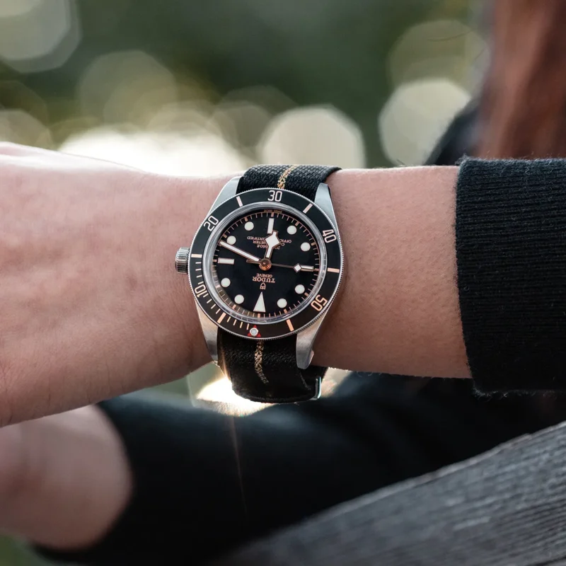 A woman wearing a tudor M79030N-0003 watch.