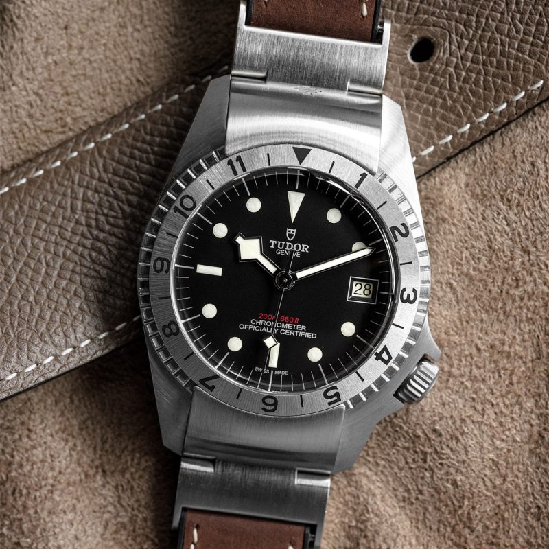 A tudor black bay watch on a brown leather strap.