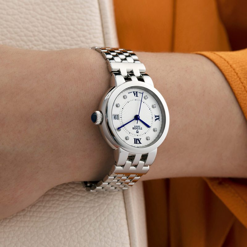 A woman's wrist with a watch on it.