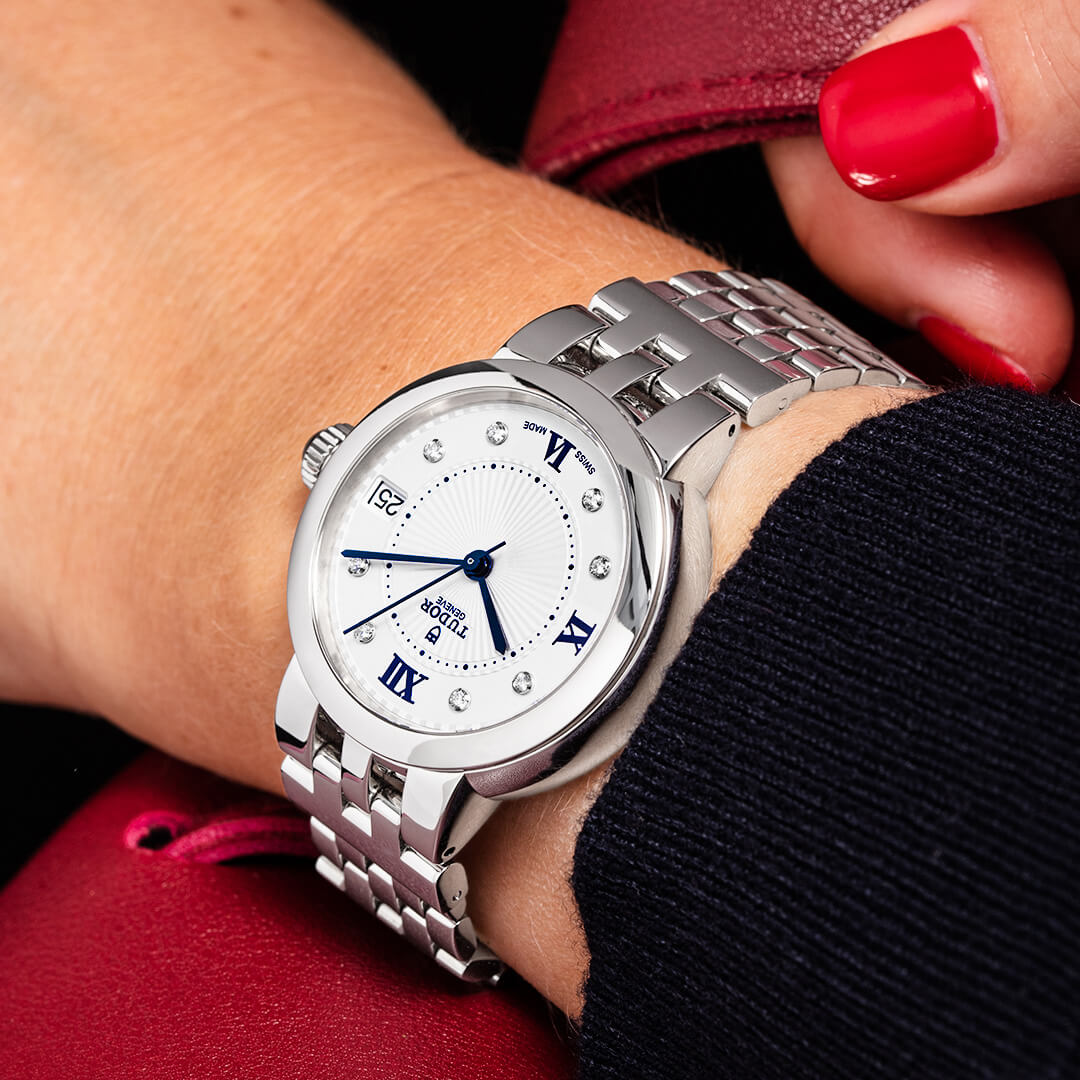 A woman's wrist with a watch on it.