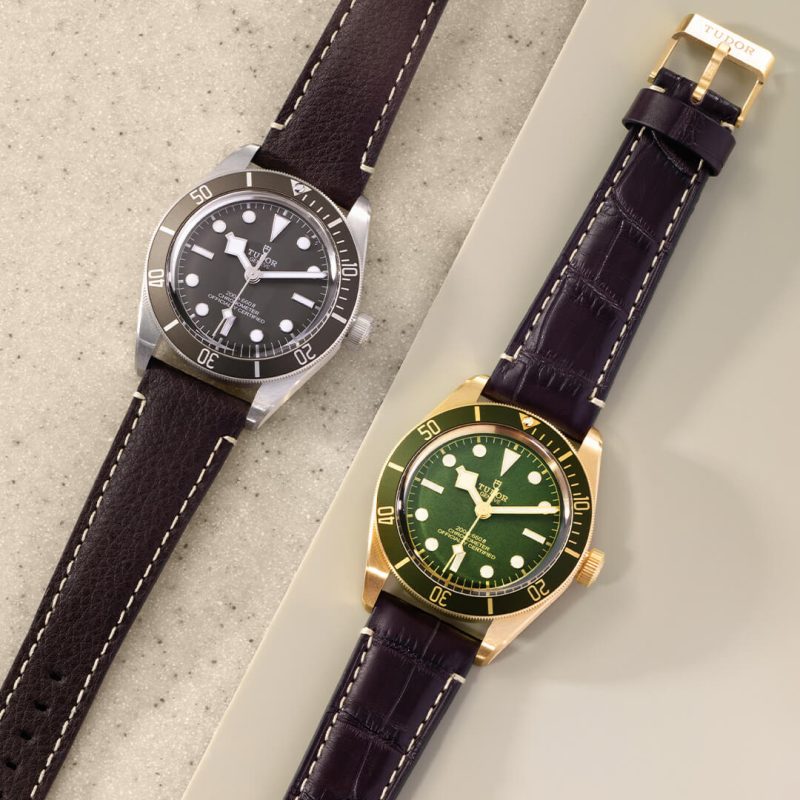 Two tudor watches with gold and green dials.