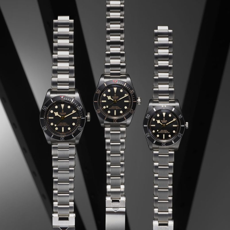 A group of watches on a shelf.