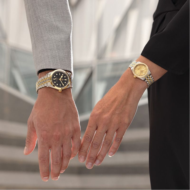 A man and woman with watches on their hands.