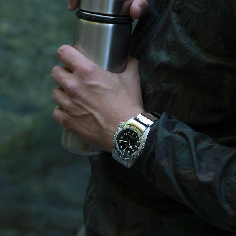 A person holding a thermos.