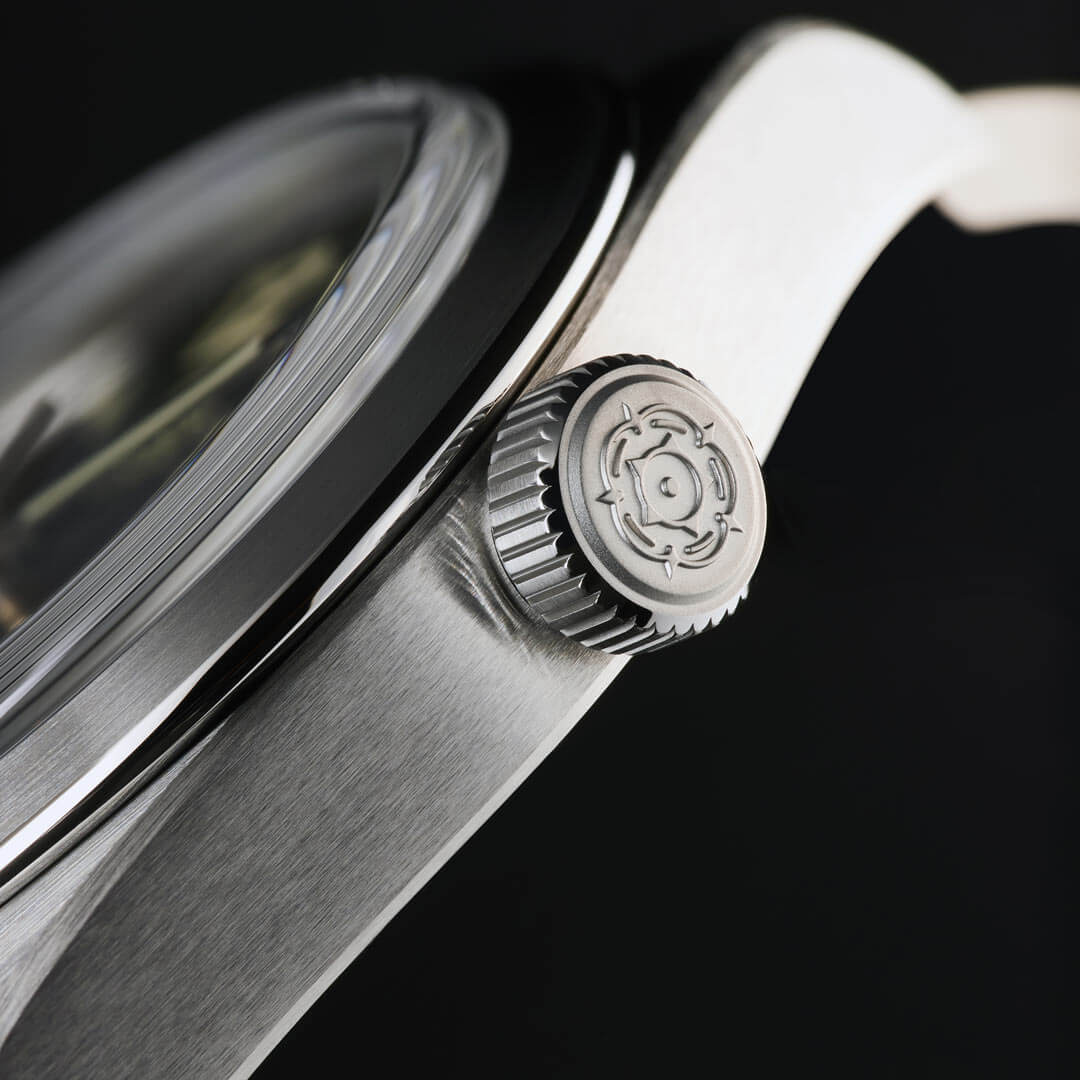 A close up of a rolex watch with a silver dial.